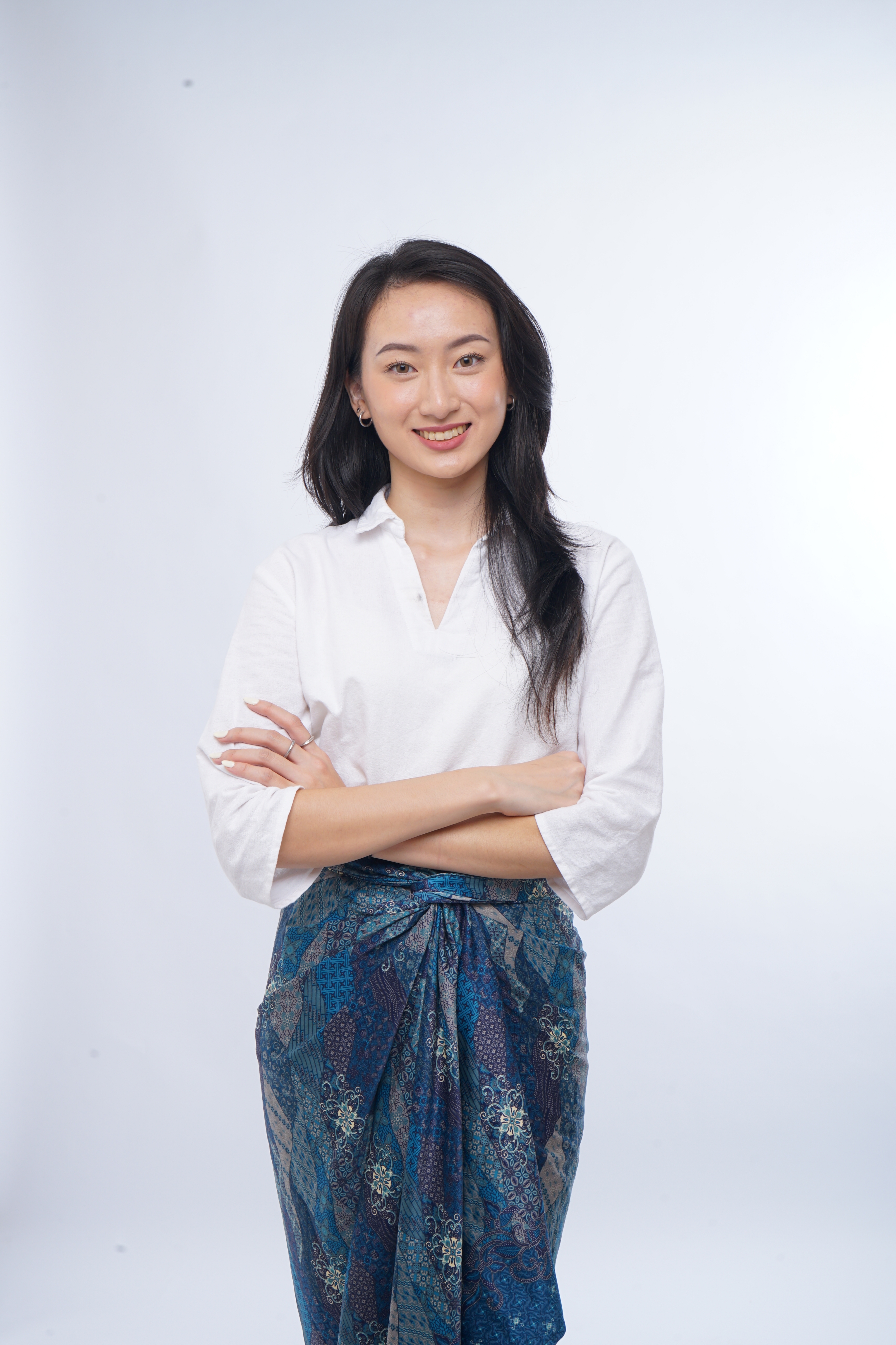 Vania Gunawan in a white blouse and blue batik
